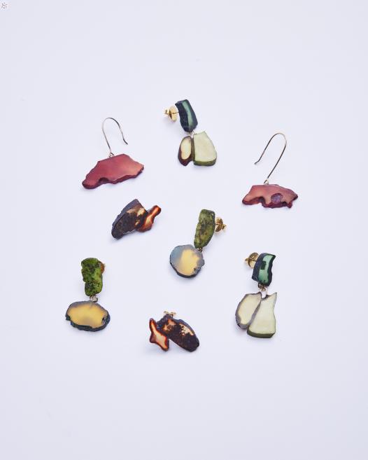 Many colorful earrings on a white background