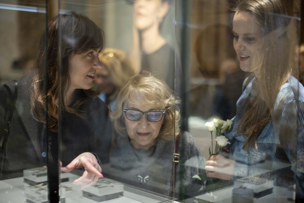 Women look at jewelry in showcases