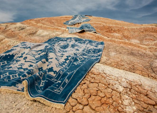 blue carpet in desert sand